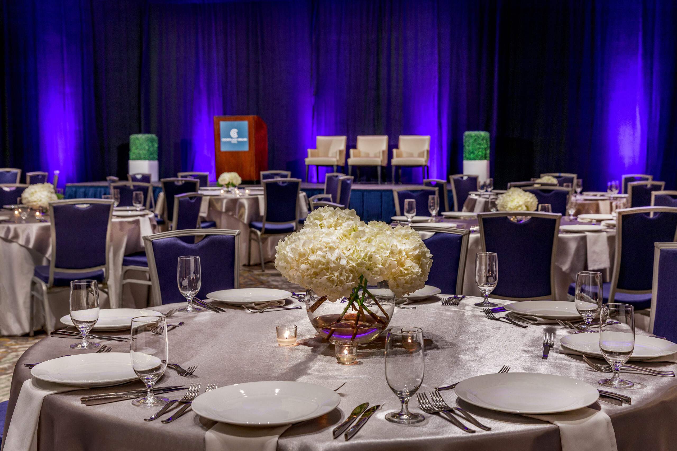 Architectural detail of The Capitol Ballroom — crystal chandelier, mahogany paneling, and gold accents